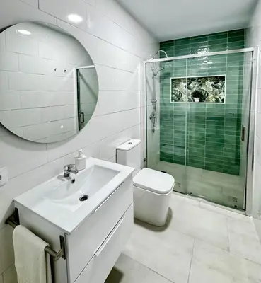 a bathroom with a sink and a toilet and a mirror at Apartamento Muñoz Fornell 3 in Chiclana de la Frontera