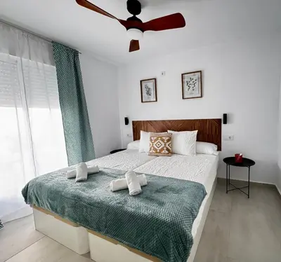 a bedroom with a bed with two towels on it at Apartamento Muñoz Fornell 3 in Chiclana de la Frontera