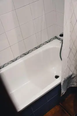 a white bath tub in a bathroom with a shower curtain at HOTEL Paquita in Chipiona
