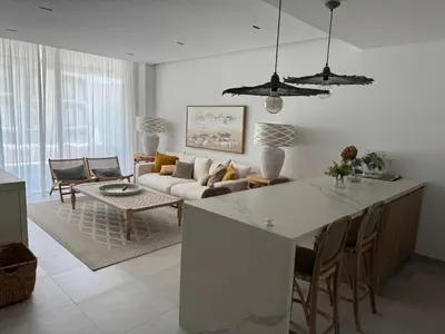 a kitchen and living room with a couch and a table at Oasis Ballena Exclusive in Cádiz