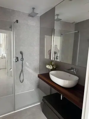 a bathroom with a white sink and a shower at Oasis Ballena Exclusive in Cádiz