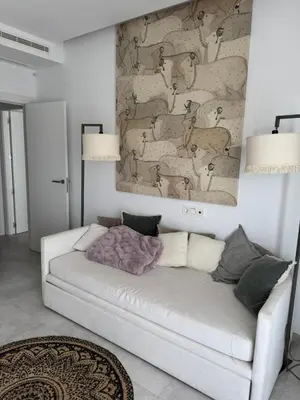a white couch in a living room with a wall at Oasis Ballena Exclusive in Cádiz