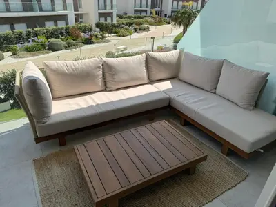 a couch sitting on a balcony with a coffee table at Oasis Ballena Exclusive in Cádiz
