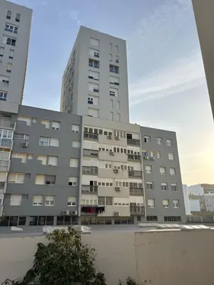 a large apartment building with a tall building at Pez Austral in Cádiz