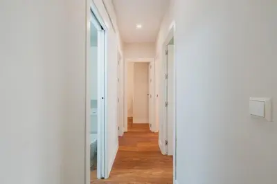 a hallway with white walls and a glass door at Pez Austral in Cádiz