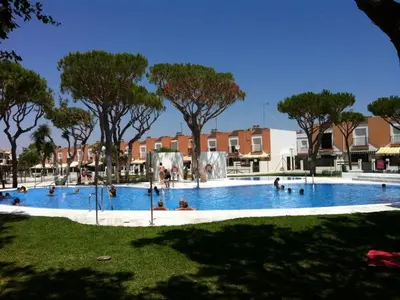 a large swimming pool with people in it at Playasol in Chiclana de la Frontera