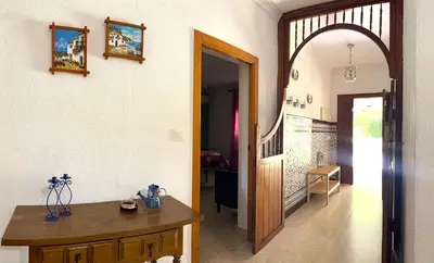 a hallway with a table and an archway in a house at Villa Las Cármenes in Conil de la Frontera
