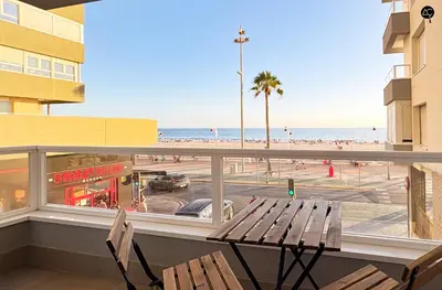 a balcony with a bench and a view of the beach at En la Orilla del Mar Grupo AC Gestion in Cádiz