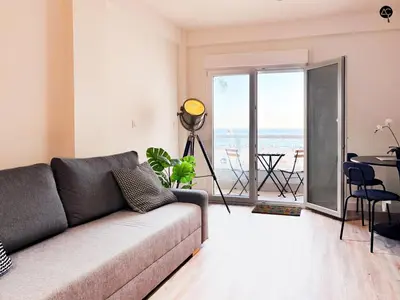 a living room with a couch and a view of the ocean at En la Orilla del Mar Grupo AC Gestion in Cádiz