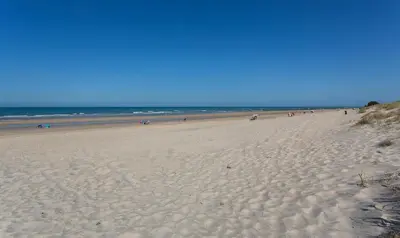 a beach with a lot of people walking on it at Ocean Costa Ballena in Chipiona
