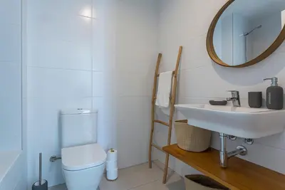 a bathroom with a sink and a toilet and a mirror at Ocean Costa Ballena in Chipiona