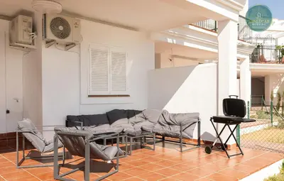 a living room with a couch and a tv at La Orilla by Sanlucar Housing in Sanlúcar de Barrameda