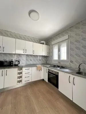 a kitchen with white cabinets and a sink at Casa Adaro in Conil de la Frontera