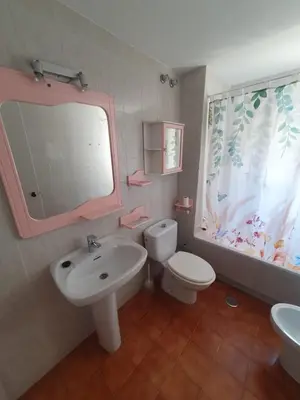 a bathroom with a sink and a toilet and a mirror at Timonel Arenas in El Puerto de Santa María