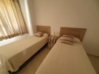 two beds sitting next to each other in a bedroom at Timonel Arenas in El Puerto de Santa María
