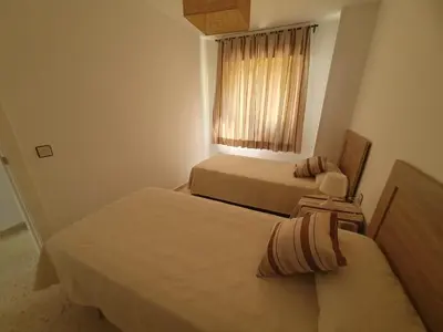 a hotel room with two beds and a window at Timonel Arenas in El Puerto de Santa María