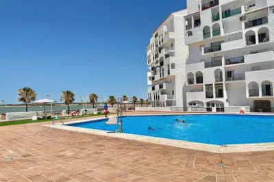a swimming pool in front of a building at Timonel Arenas in El Puerto de Santa María