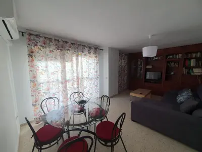 a living room with a glass table and chairs at Timonel Arenas in El Puerto de Santa María