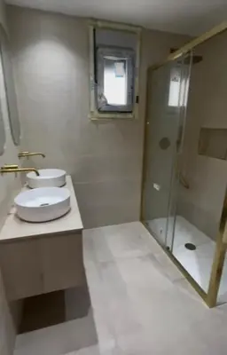 a bathroom with a toilet and a glass shower at Casa Isabel 29 in Chipiona