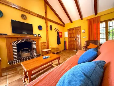 a living room with a couch and a fireplace at Villa La Alegría in Conil de la Frontera