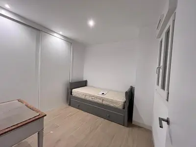 a small bedroom with a bed in a room at Casa El Puerto in El Puerto de Santa María