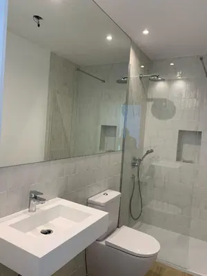 a bathroom with a toilet and a sink and a shower at Casa El Puerto in El Puerto de Santa María