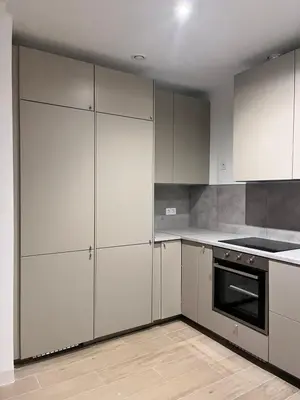 an empty kitchen with white cabinets and a stove at Casa El Puerto in El Puerto de Santa María