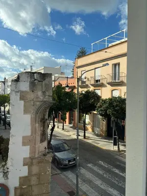 a car parked on a street next to a building at Casa El Puerto in El Puerto de Santa María