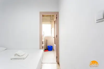 a bedroom with a white bed and a window at Teresa Uno by Cadiz Time in Cádiz