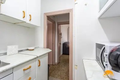 a kitchen with white cabinets and a microwave at Teresa Uno by Cadiz Time in Cádiz