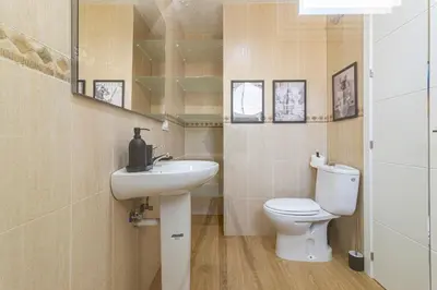 a bathroom with a white toilet and a sink at Allo Apartments Merced Duplex Centro 2 habitaciones - 2 Baños in Jerez de la Frontera