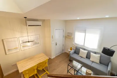 a living room with a couch and a table at Allo Apartments Merced Duplex Centro 2 habitaciones - 2 Baños in Jerez de la Frontera
