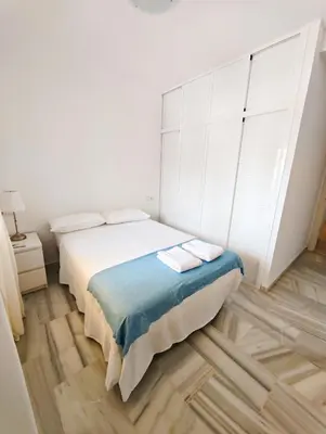 a white bedroom with a bed and a large window at Primera Linea Costa Ballena con Vista al Mar in Costa Ballena