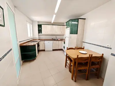 a small kitchen with a wooden table and chairs at Primera Linea Costa Ballena con Vista al Mar in Costa Ballena