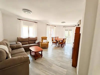 a living room with a couch and a table and chairs at Primera Linea Costa Ballena con Vista al Mar in Costa Ballena