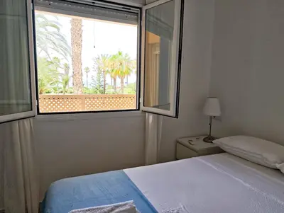 a bedroom with a bed and a large window at Primera Linea Costa Ballena con Vista al Mar in Costa Ballena