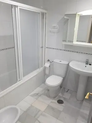 a white bathroom with a toilet and a sink at Primera Linea Costa Ballena con Vista al Mar in Costa Ballena