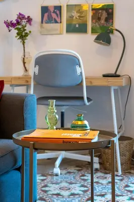 a table with a chair and a table with a desk at Casa Bombón in Medina Sidonia