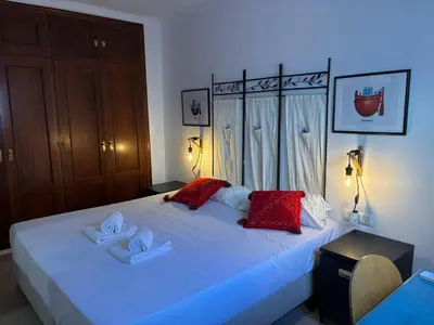 a bedroom with a bed with two towels on it at Casa del Oratorio 1812 in Cádiz