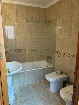 a bathroom with a tub and a toilet and a sink at Casa del Oratorio 1812 in Cádiz