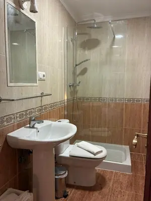 a bathroom with a sink and a shower and a toilet at Casa del Oratorio 1812 in Cádiz