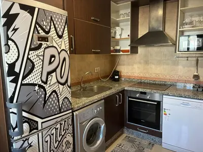 a kitchen with a washing machine and a sink at Casa del Oratorio 1812 in Cádiz
