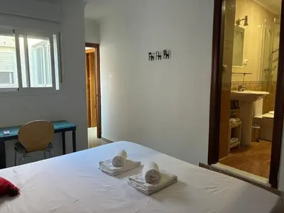 a bedroom with a bed with two towels on it at Casa del Oratorio 1812 in Cádiz