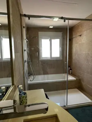 a bathroom with a shower and a sink and a tub at Apartoyou - Puerto Paradise in Inmaculada