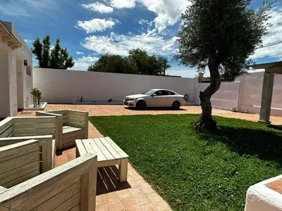 a white car parked in a yard with a tree at Apartoyou - Puerto Paradise in Inmaculada