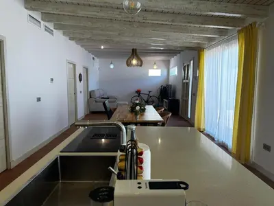a kitchen with a sink and a living room at Apartoyou - Puerto Paradise in Inmaculada