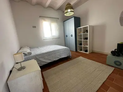 a bedroom with a bed and a window at Apartoyou - Puerto Paradise in Inmaculada
