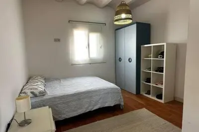 a bedroom with a bed and a cabinet and a lamp at Apartoyou - Puerto Paradise in Inmaculada