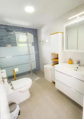 a bedroom with two beds and a desk with a lamp at Casa Gadir in Sanlúcar de Barrameda