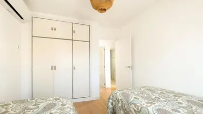 a bedroom with a black dresser and a mirror at Casa Gadir in Sanlúcar de Barrameda
